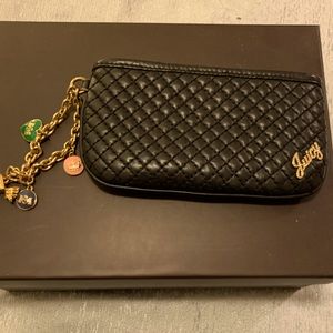 Juicy Couture charmed wristlet in black.